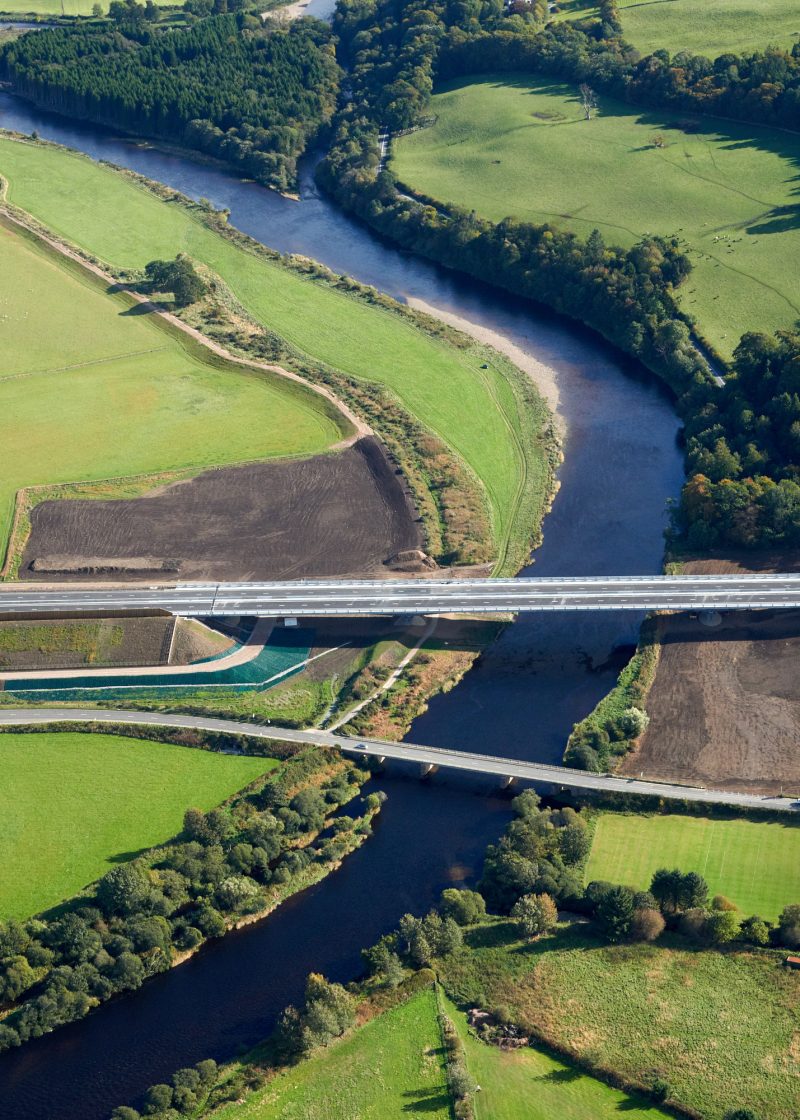 Bridge over a river in a field