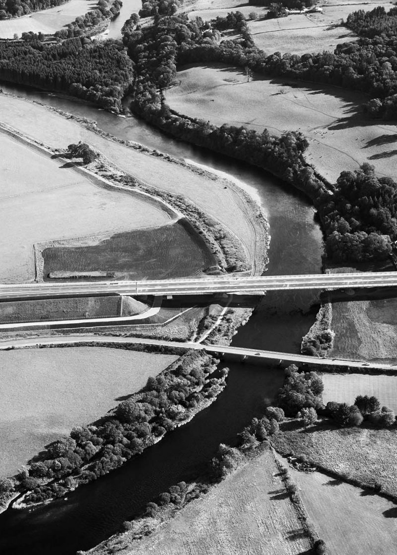 Bridge over a river in a field